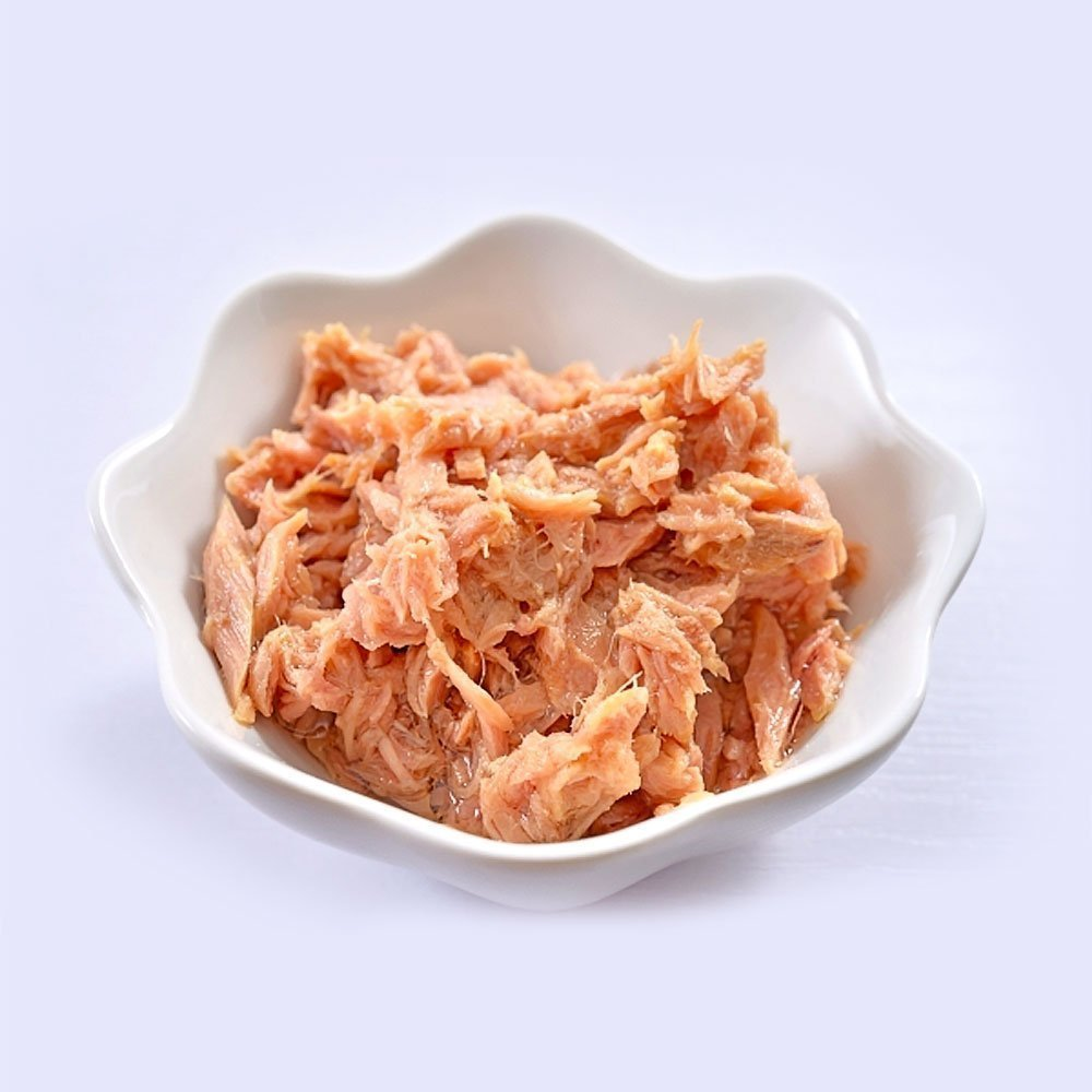 A canned tuna in a small white bowl